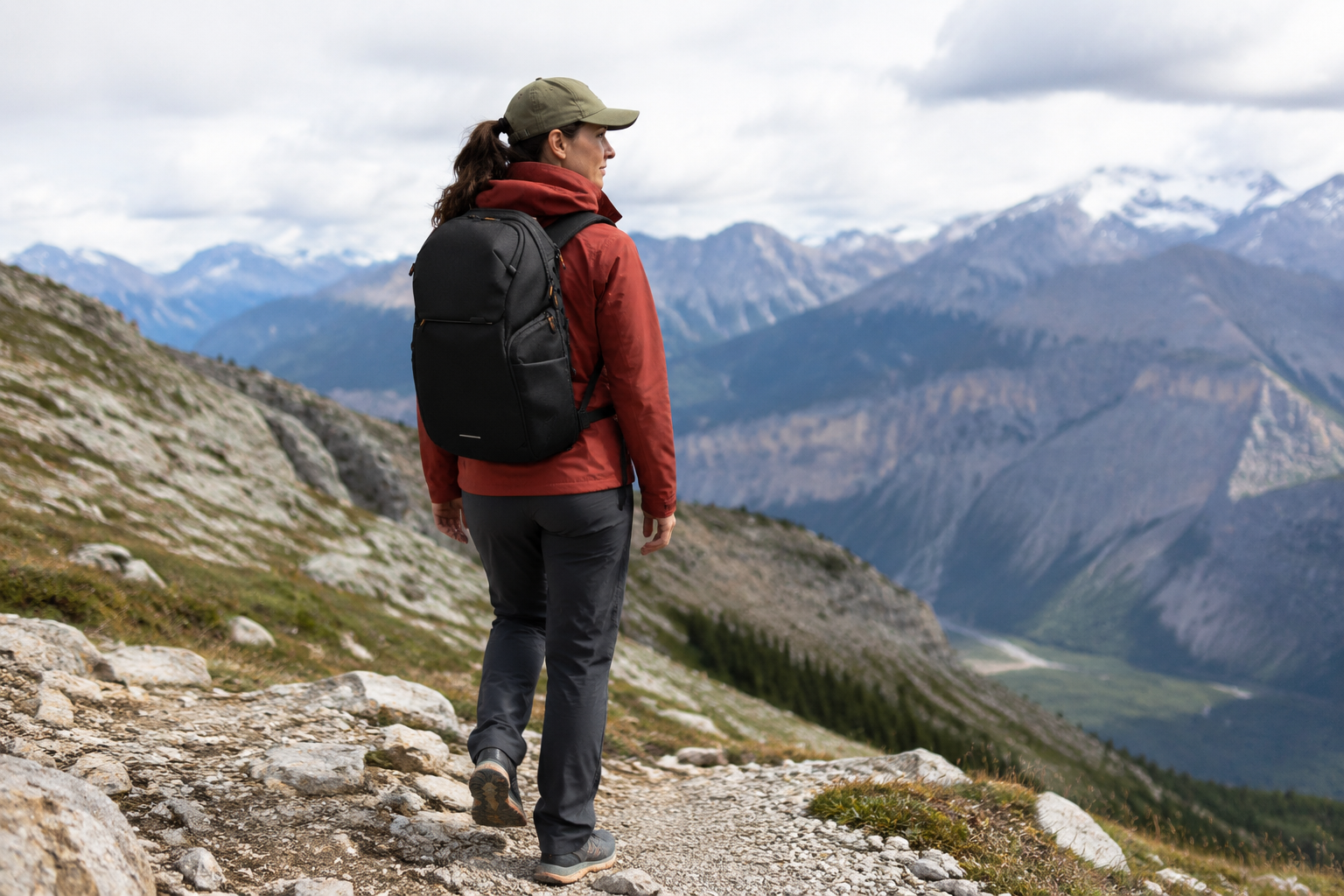 NENEXS backpack carried by a hiker above a mountain valley